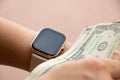 smart watch on the girl& x27;s hand took dollar bills on the street, money