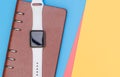 Smart watch on notebook for organize with blue pink yell