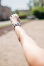 Smart watch on sporting girl wrist. Smart watch health, heart rate and fat burn monitoring. Jogging goals preparation. Lifestyle Royalty Free Stock Photo