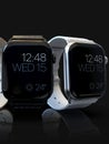 2 smart watches - Apple Watch 4, silver and black, on dark Royalty Free Stock Photo