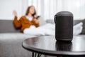 Woman controlling home devices with a voice commands