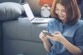 Smart Woman Explore Online Shopping Website on smartphone. Smiling face of asian woman holding cellphone with E-commerce Shopping Royalty Free Stock Photo