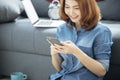 Smart Woman Explore Online Shopping Website on smartphone. Smiling face of asian woman holding cellphone with E-commerce Shopping Royalty Free Stock Photo