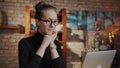 Smart woman in glasses working at home on laptop in home office Royalty Free Stock Photo