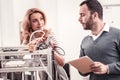 Smart woman showing colleague how to use 3D printer Royalty Free Stock Photo