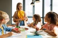 Teacher conducts a lesson, gives a lecture children during school work Royalty Free Stock Photo