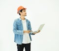 Smart young asian architect engineer man wear casual jean and orange safety helmet which hand holding laptop to check his plan Royalty Free Stock Photo