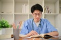 Smart young Asian male medical student reading a book, preparing for exam Royalty Free Stock Photo