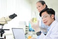 Smart young Asian male scientist or chemist doing a chemical experiment in the lab Royalty Free Stock Photo