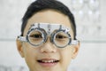 Young boy examining eyesight in optical clinic. Royalty Free Stock Photo
