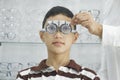 Young boy examining eyesight in optical clinic. Royalty Free Stock Photo