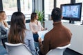 Smart young business people working and talking of they new project while doing a video call with company director in coworking Royalty Free Stock Photo