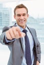 Smart young businessman in suit pointing at you