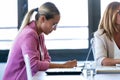 Smart young businesswoman working with digital tablet on coworking place Royalty Free Stock Photo