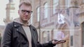 Smart young man shows hologram two floored bus