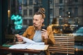 Smart young man studying in street cafe Royalty Free Stock Photo