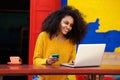 Smart young woman using laptop at outdoor coffee shop