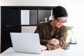 Smart youngadult 40s asian man with eye glasses working on laptop or computer notebook in modern working space. office life and