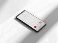 Smartphone with active call screen on white surface Royalty Free Stock Photo
