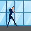 Smartphone addiction. Attractive young businessman using smartphone walking in front of a modern office building. Royalty Free Stock Photo