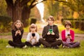 Smartphone addiction group of children watching film movie cartoon together on digital tablet. Kids playing with phone Royalty Free Stock Photo