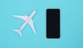 Smartphone and airplane on sky blue background. Smartphone application for online searching, buying and booking flights on the int