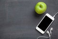 Smartphone and apple on blackboard background Royalty Free Stock Photo