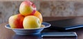 Smartphone, apples on a plate and a laptop. Healthy break.