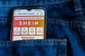 Smartphone in the back pocket of a jean, on the screen the Shein app Store