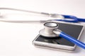 Smartphone being diagnosed by stethoscope - phone repair and check up concept Royalty Free Stock Photo