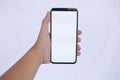 Hand Holding Smartphone with Blank White Screen on light Background Royalty Free Stock Photo