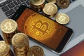 Smartphone with Bitcoin symbol on-screen laying on computer keyboard Royalty Free Stock Photo