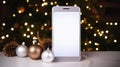 Smartphone with blank screen and christmas decoration on table against blurred background Royalty Free Stock Photo