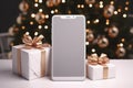 Smartphone with blank screen and gift boxes on white table in front of christmas tree Royalty Free Stock Photo