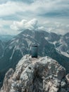 Smartphone with blank screen perched on mountain peak with expansive views of mountains range. Royalty Free Stock Photo