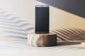 Smartphone with blank screen on wooden podium in warm minimalistic setting. 3D Rendering Royalty Free Stock Photo