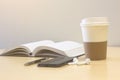 Smartphone  with Book turning pages  and a cup of coffee Royalty Free Stock Photo
