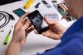 Smartphone with broken cracked screen in technician hands. phone repair service Royalty Free Stock Photo