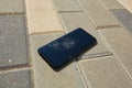 Smartphone with a broken screen on pavement. mobile phone fell and crashed on sidewalk Royalty Free Stock Photo