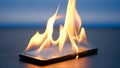 Smartphone is burning on a table on a blue background