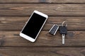 Smartphone, car keys on the background Royalty Free Stock Photo