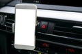 Smartphone in a car use for Navigate or GPS. Driving a car with Smartphone in holder. Mobile phone with isolated white screen. Royalty Free Stock Photo