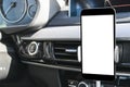 Smartphone in a car use for Navigate or GPS. Driving a car with Smartphone in holder. Mobile phone with isolated white screen. Royalty Free Stock Photo