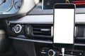 Smartphone in a car use for Navigate or GPS. Driving a car with Smartphone in holder. Mobile phone with isolated white screen. Royalty Free Stock Photo