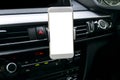 Smartphone in a car use for Navigate or GPS. Driving a car with Smartphone in holder. Mobile phone with isolated white screen. Royalty Free Stock Photo