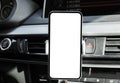 Smartphone in a car use for Navigate or GPS. Driving a car with Smartphone in holder. Mobile phone with  white screen. Bla Royalty Free Stock Photo