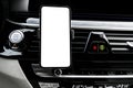 Smartphone in a car use for Navigate or GPS. Driving a car with Smartphone in holder. Mobile phone with isolated white screen. Bla Royalty Free Stock Photo