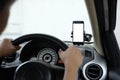 Smartphone in a car use for Navigate or GPS. Smartphone in holder. Mobile phone with isolated white screen. Royalty Free Stock Photo
