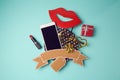 Smartphone with cardboard banner, lipstick and gift box. Creative website hero image.