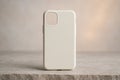 Blank smartphone case mockup standing upright on stone surfaceâminimal phone accessory stock photo Royalty Free Stock Photo